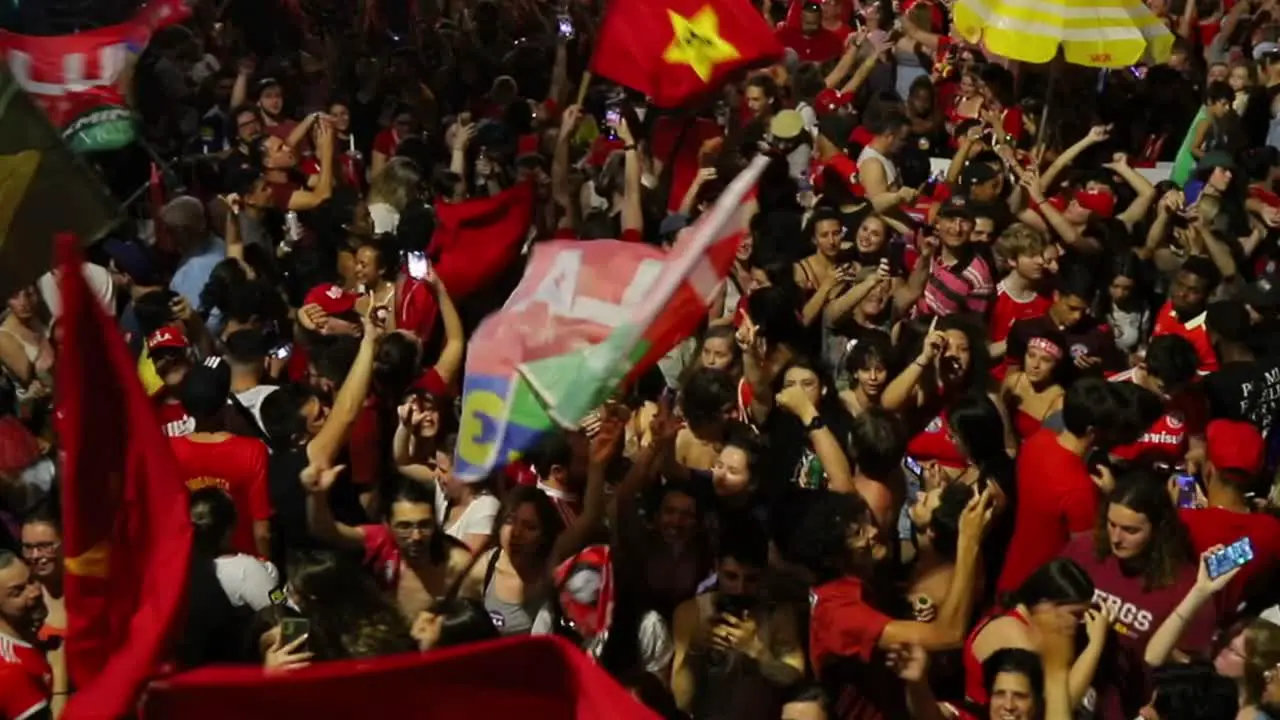 People take to the streets in Porto Alegre Brazil waving flags in celebration of the election of Luiz Inácio Lula da Silva