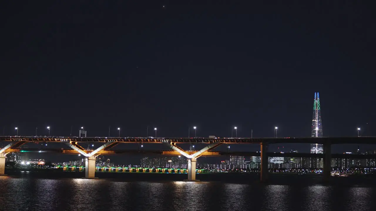 Cheongdam bridge at night crossing Han river with Lotte tower in background