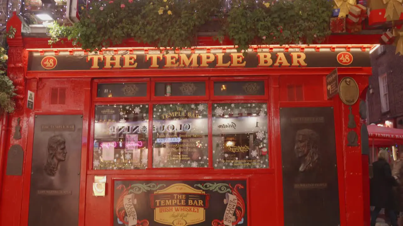 Dublin Ireland People Strolling by Temple Bar During the Nighttime Pan Down Shot