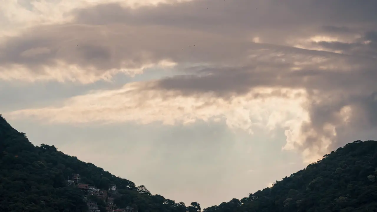 Time Lapse Of Storm Cloud Formations Passing By Mountains Sun Rays Shining Through