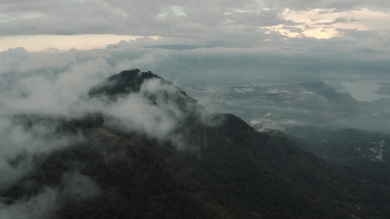 Drone aerial flying high over cloudy misty mountains in Guatemala