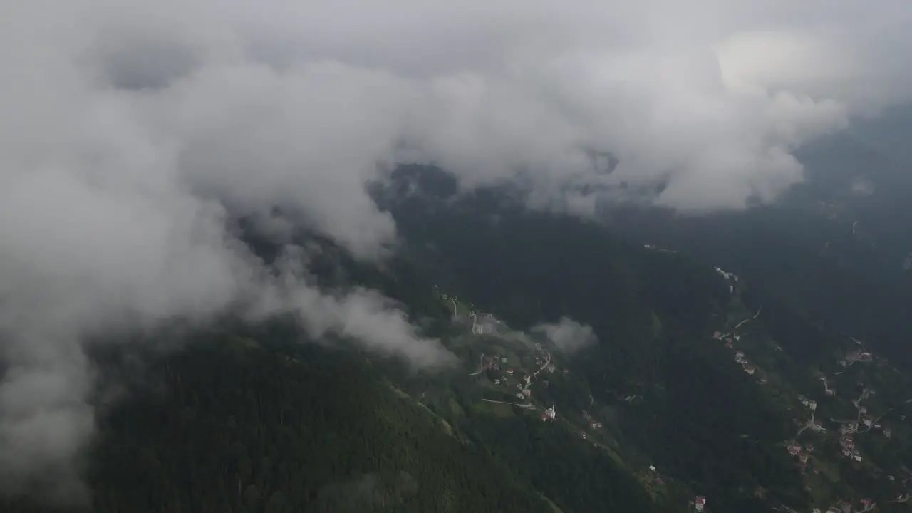 Drone view of mountain and rural settlement on an overcast and foggy day