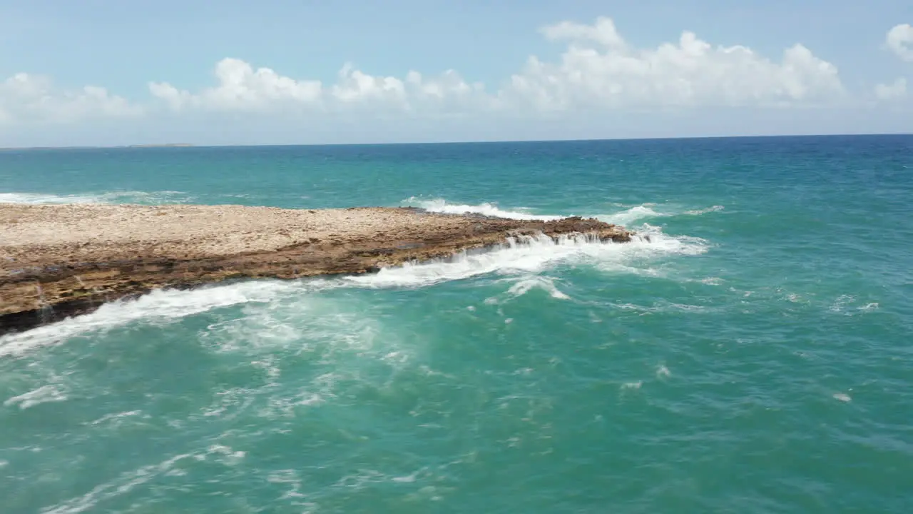 Aerial scenic revealing view stormy caribbean shore with crashing waves and beautiful nature