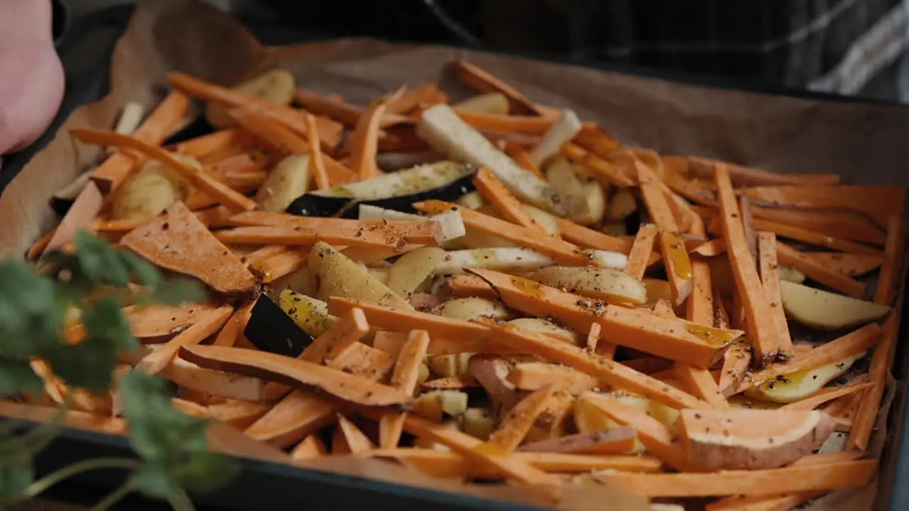 Slow-Motion Footage Of A Chef taking baking sheet with Vegetables cooking a healthy meal