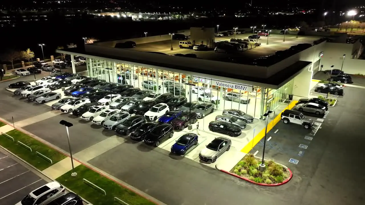 Valencia BMW luxury car dealership nighttime aerial flyover