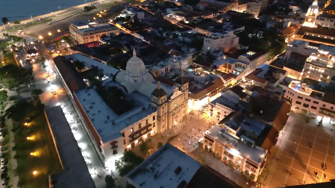 Aerial Drone Fly Above Cartagena Colombia at Night Cathedral Historical Center Buildings Panoramic City View