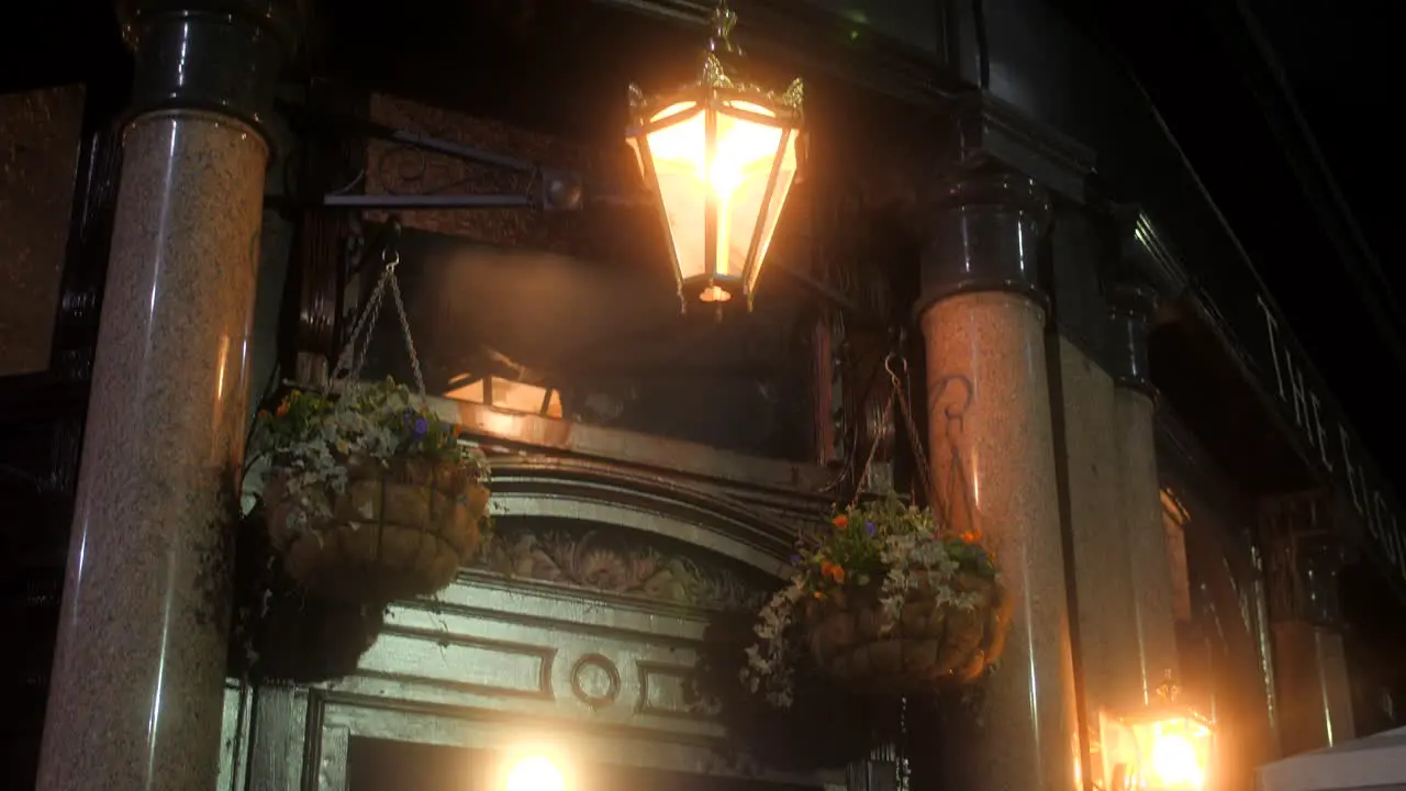 Public House Facade With Vintage Lamps During The Night