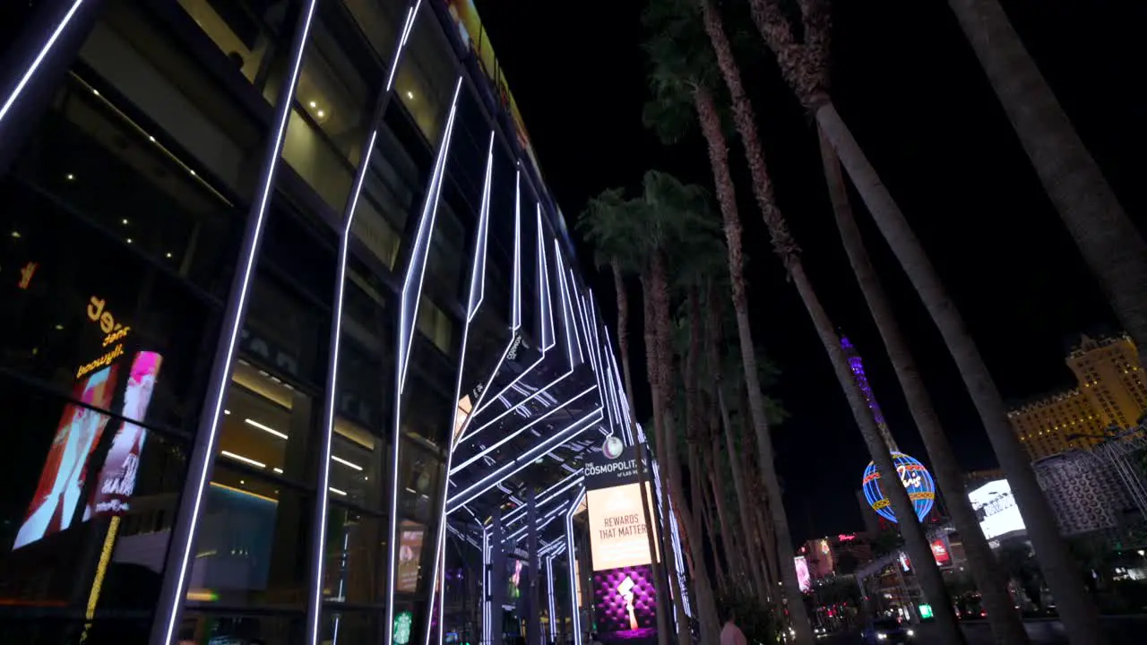 Rotating view looking up at palm trees and neon lights on street Las Vegas nightlife