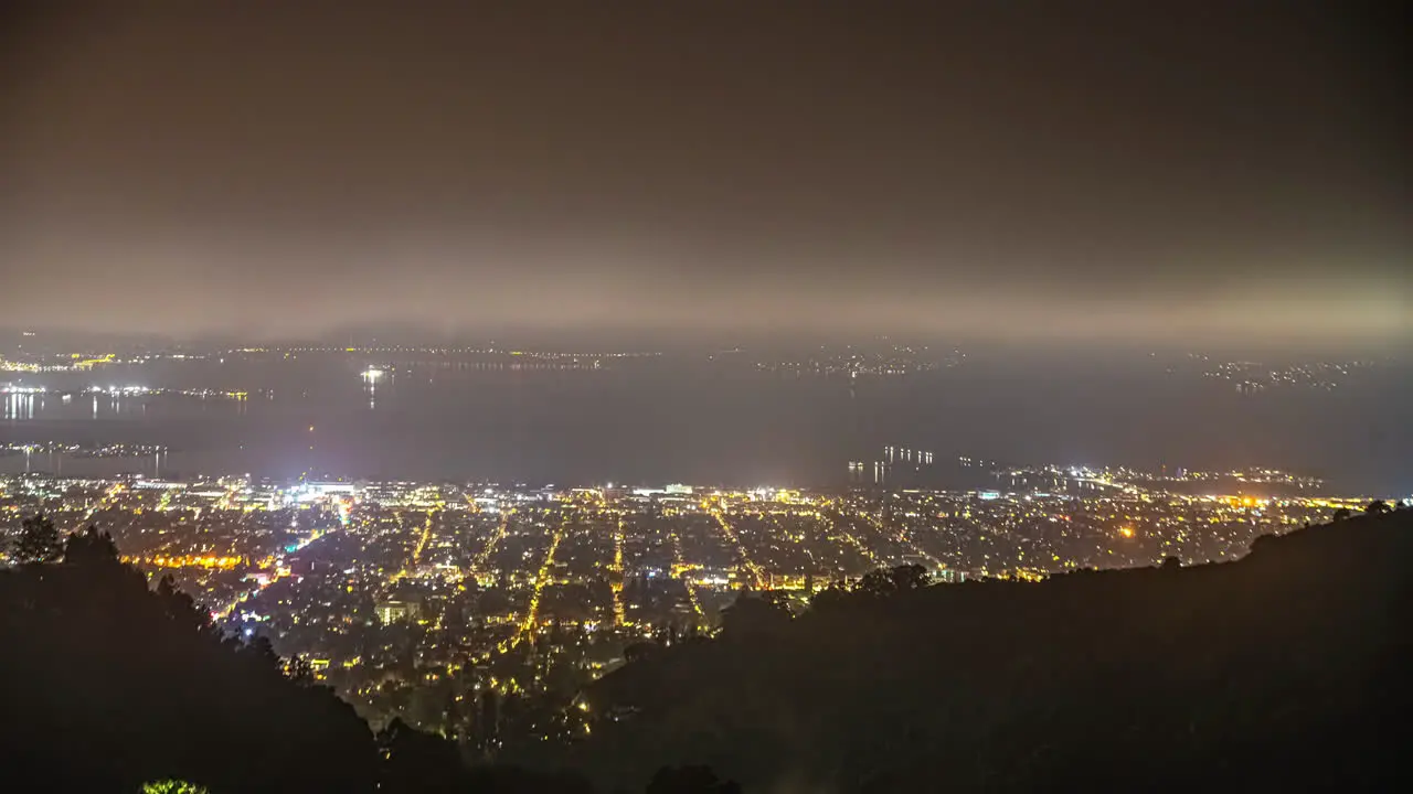 Oakland and the San Francisco Bay California as seen from Grizzly Peak overlook misty nighttime time lapse