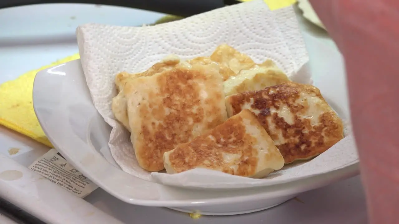 Fried cheese on a plate with absorbent paper