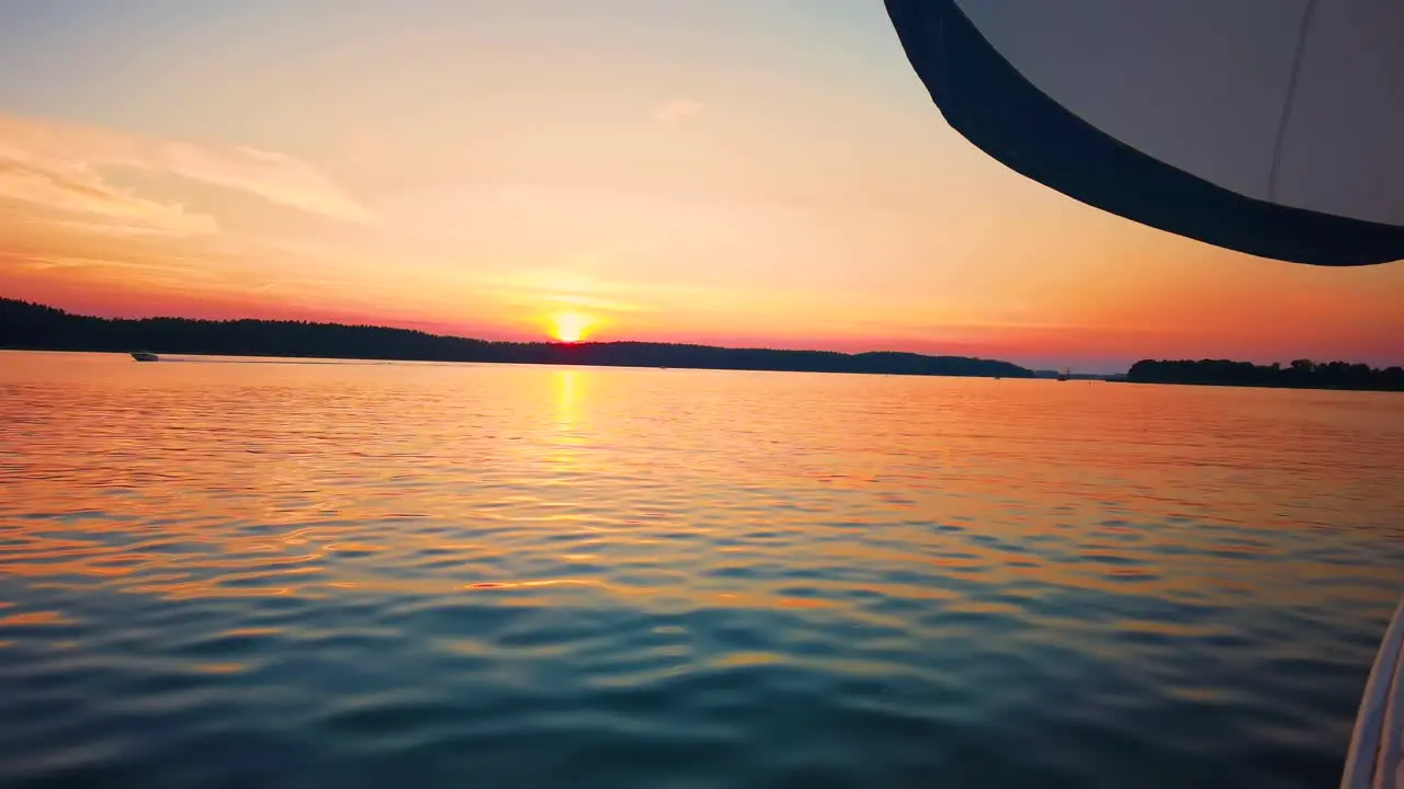 The front bow of a white sailing boat with blue sky and sea background