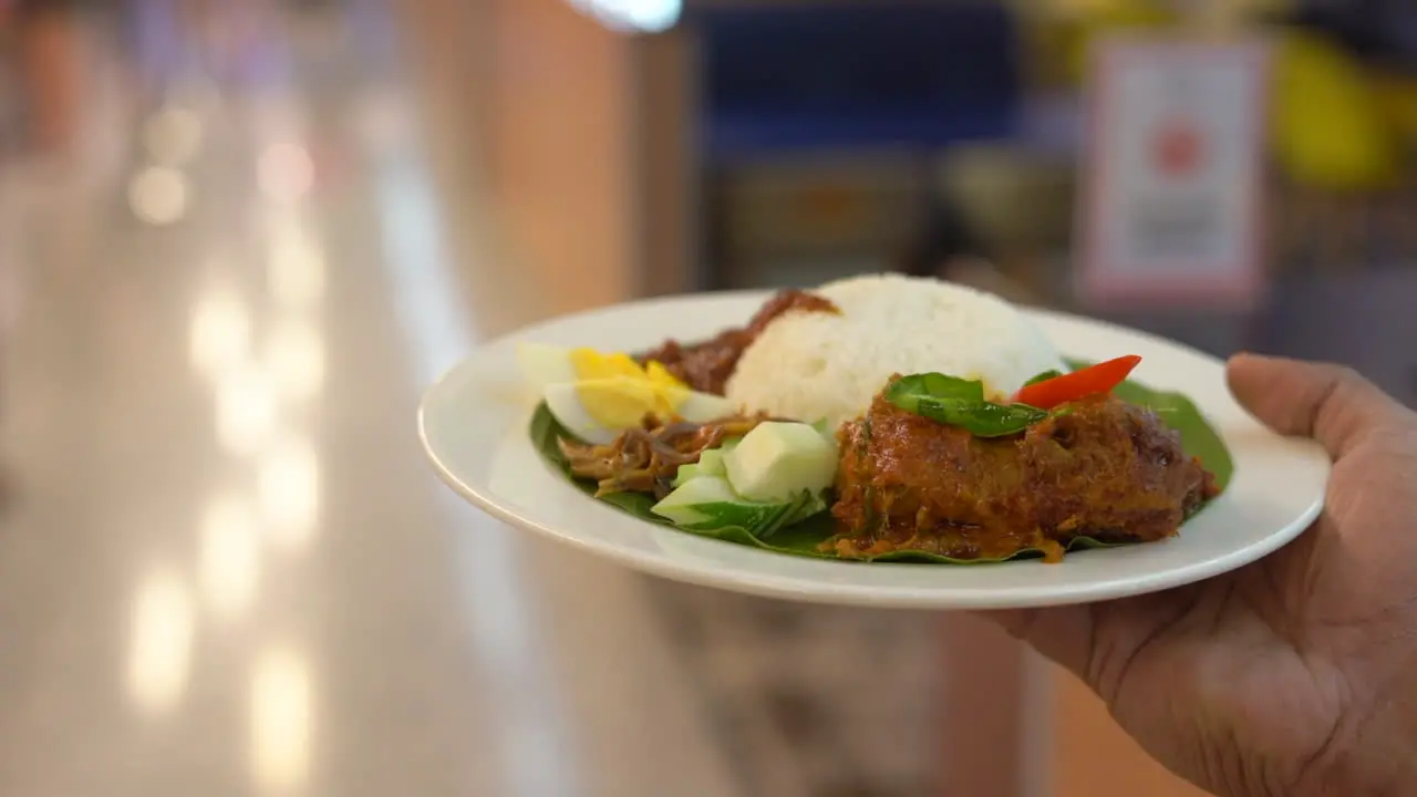 One man woke with a rice plate holding on hand