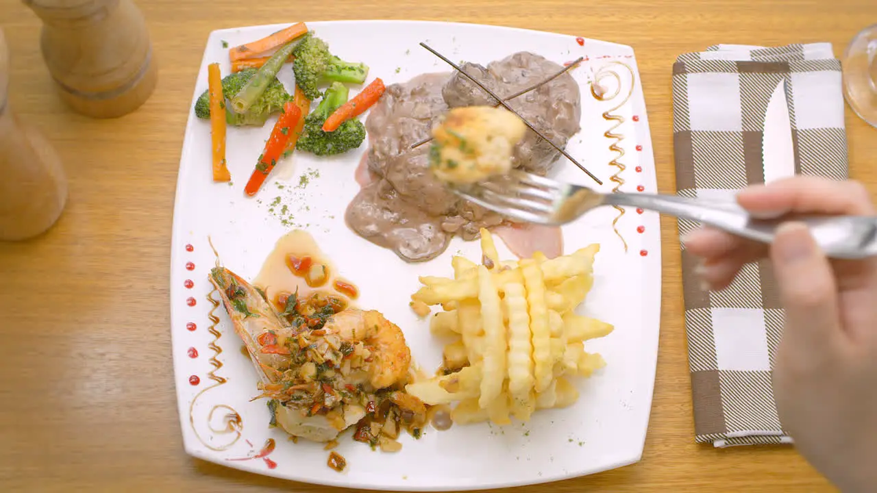 Meat in sauce prawns French fries and salad Mediterranean