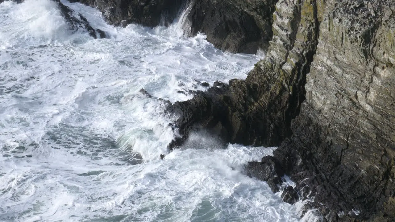 Waves Crashing Against Rocks Beneath Ocean Bird Colony