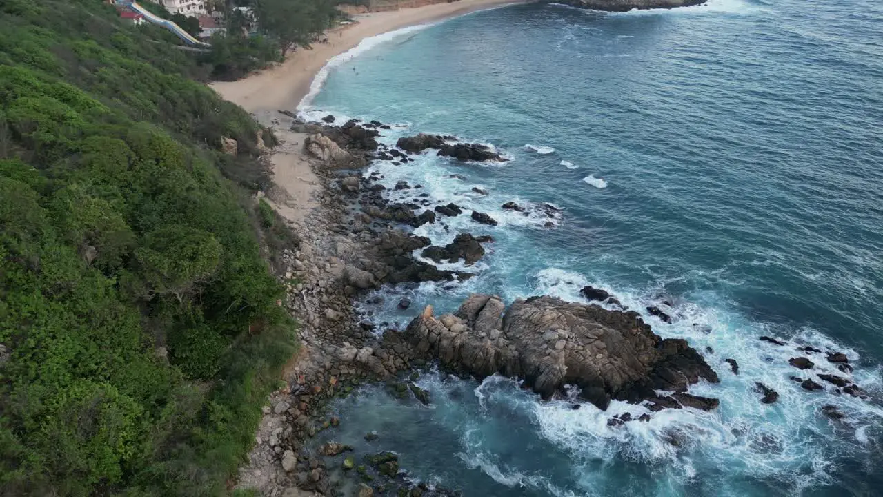 This drone video captures the sea crashing against the rocks near Coral and Bacocho beaches in Puerto Escondido Oaxaca Mexico