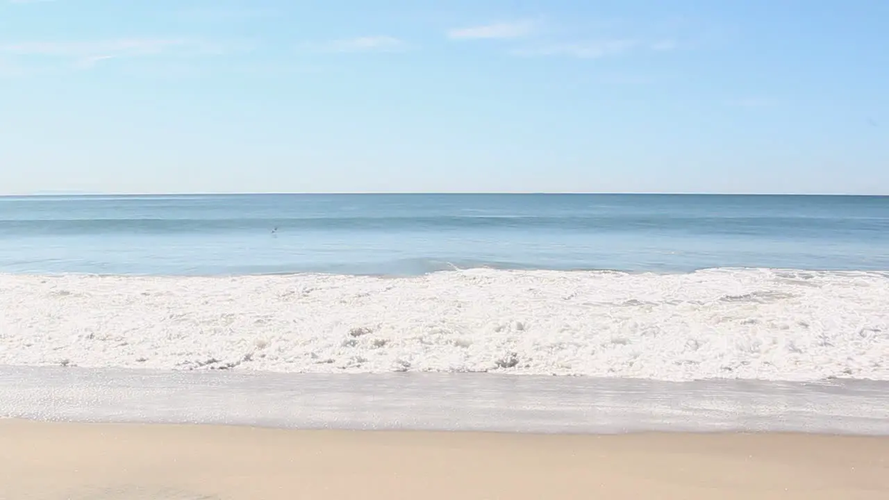 waves crash at the beach in the daytime