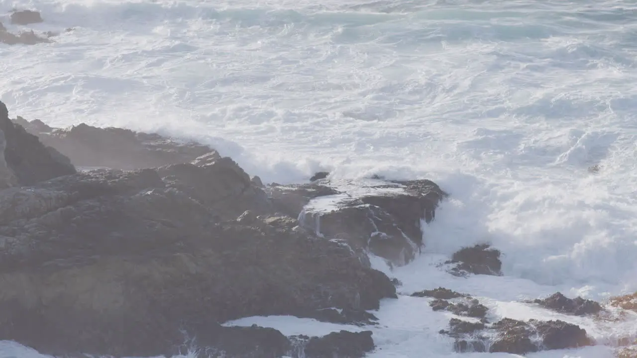 close shot of white water waves crashing along the rocks of Big Sur California