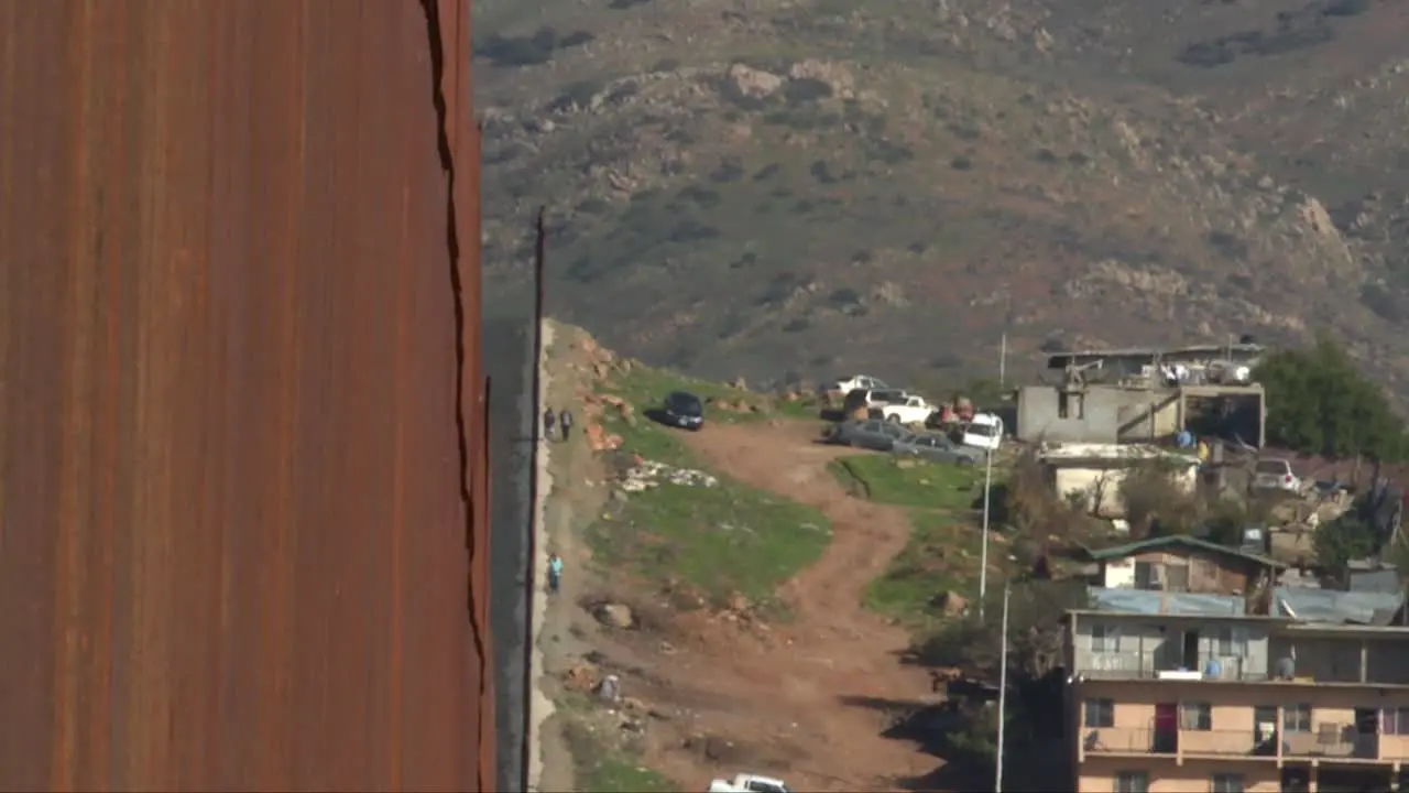 medium shot people walking next to border barrier