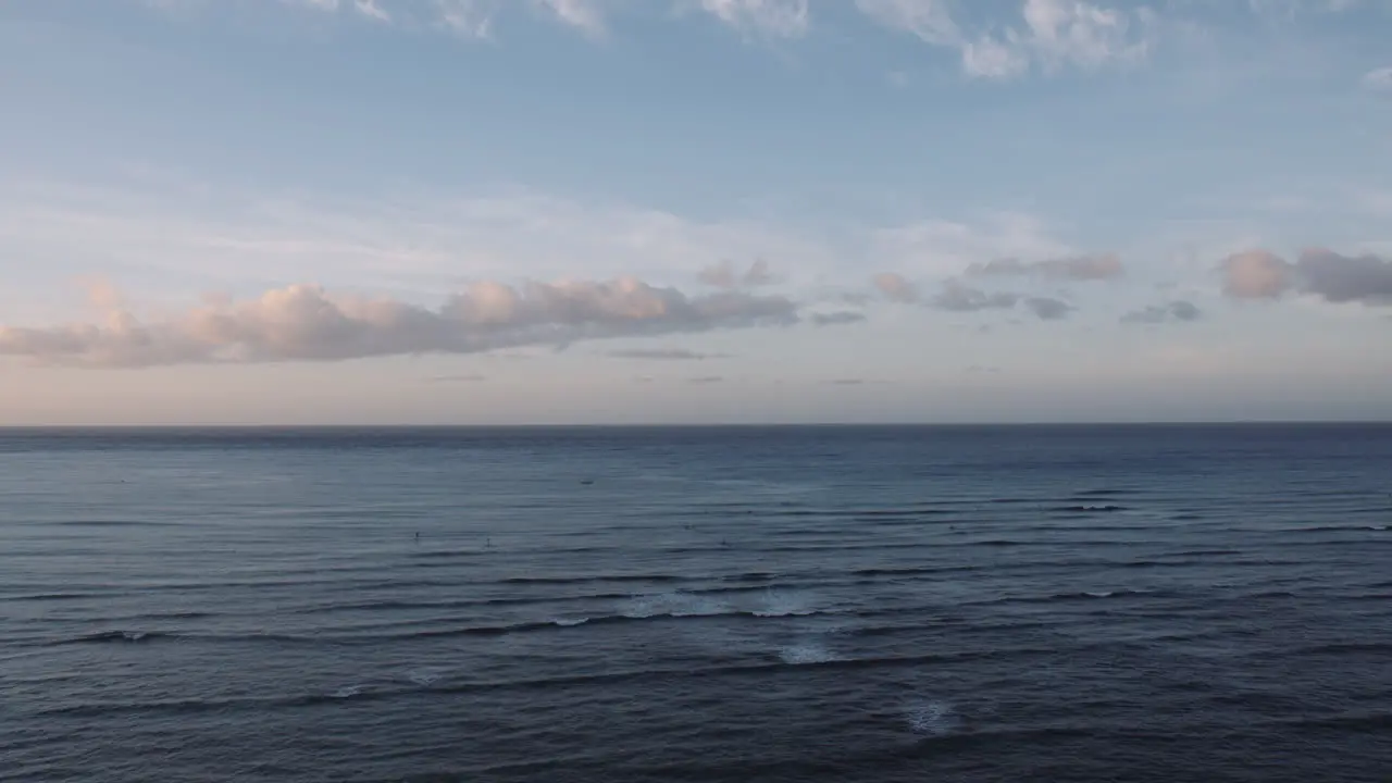 Calm Rolling Waves and Colorful clouds at Sunrise Waikiki beach Aerial shot