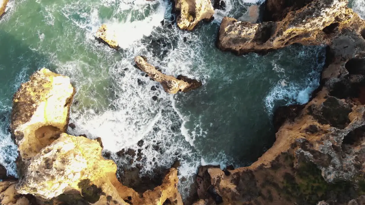 Top view of Atlantic Ocean waves crashing on cliffs