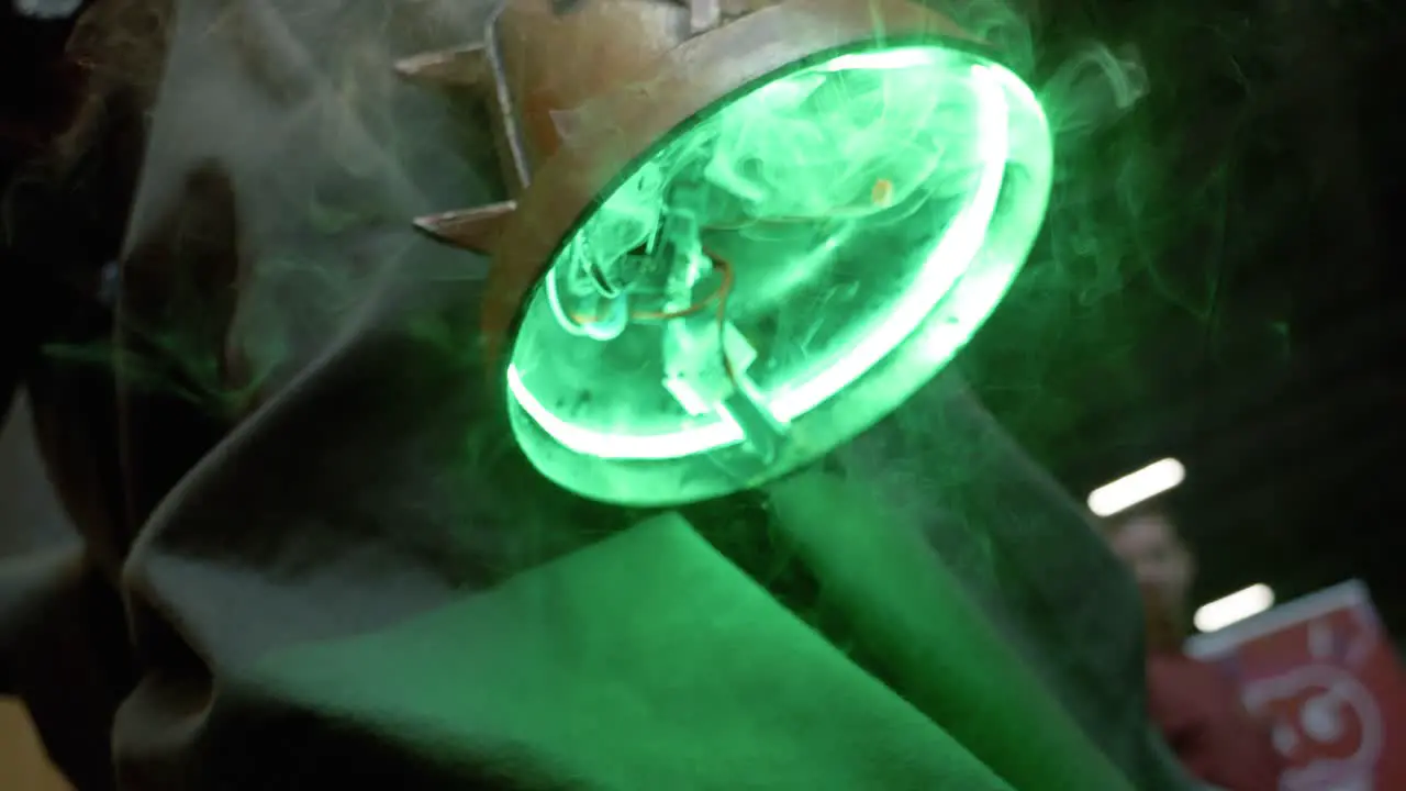 Slowmotion close-up shot of a bright green neon lamp with smoke trailing