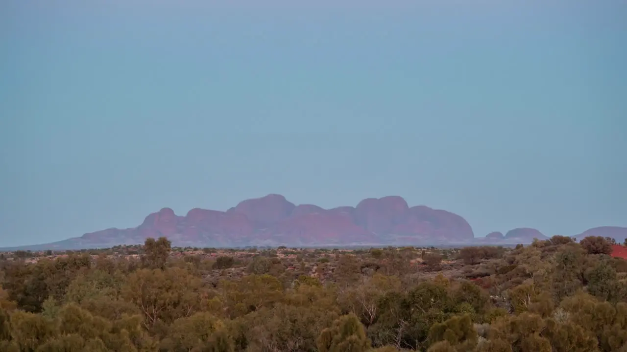 A time lapse of a full moon setting behind Kata-Tjuta shortly before sunrise in the Australian Outback