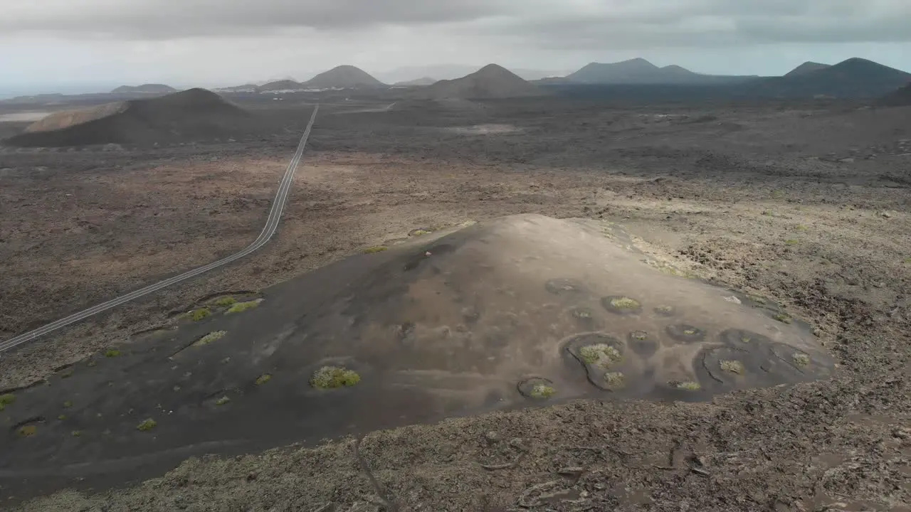 Aerial view of a road crossing through a volcanic landscape