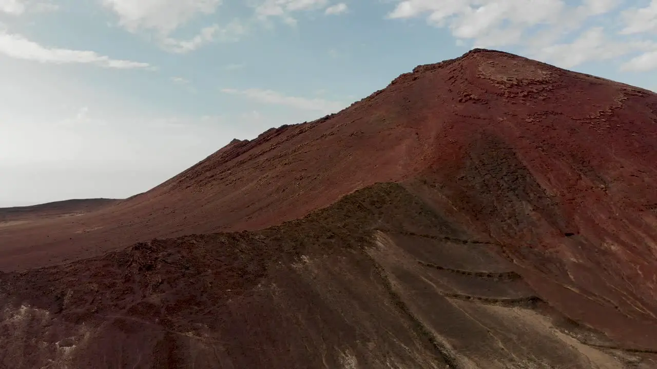 Flying by a red volcanic mountain