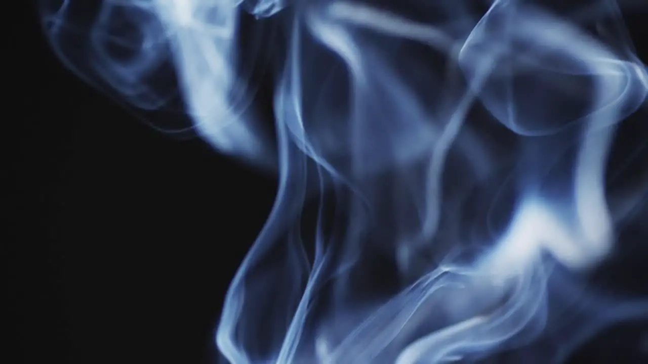 Video of white clouds of smoke moving with copy space on black background