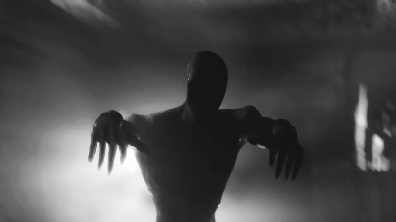 Animation of scary zombie mummy walking in dark crypt with burning torches in black and white