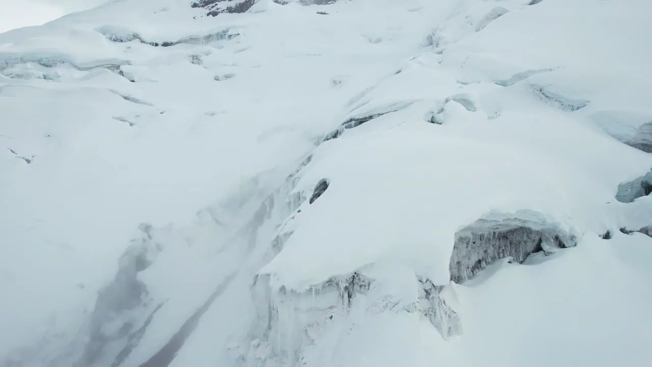 Drone Aerial View of Glacier Frozen Ice and Snow in Mountains on High Elevation Cotopaxi Volcano Ecuador Drone Shot