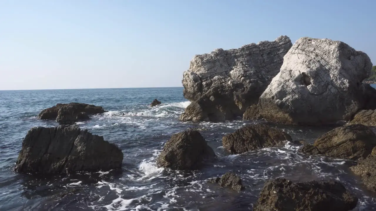 Steady shot of big rocks in the sea in sunny warm day Montenegro