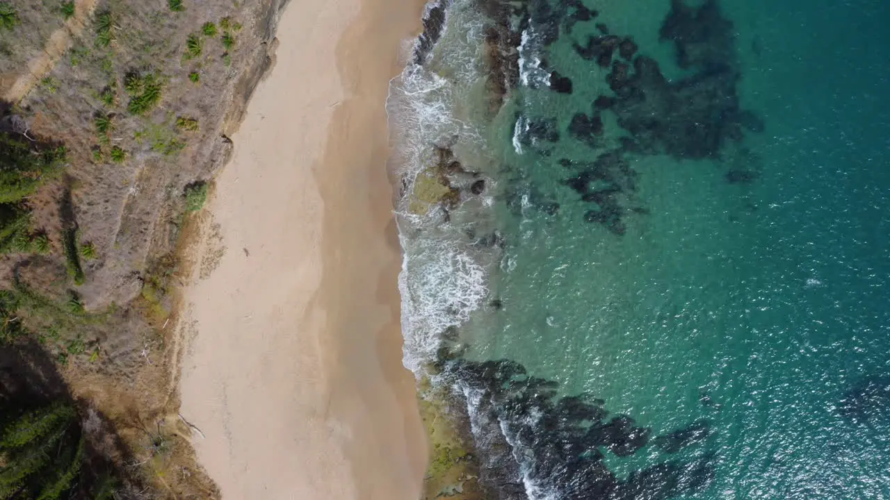 Beautiful drone shot of a beach and the transparent sea from a bird eye view