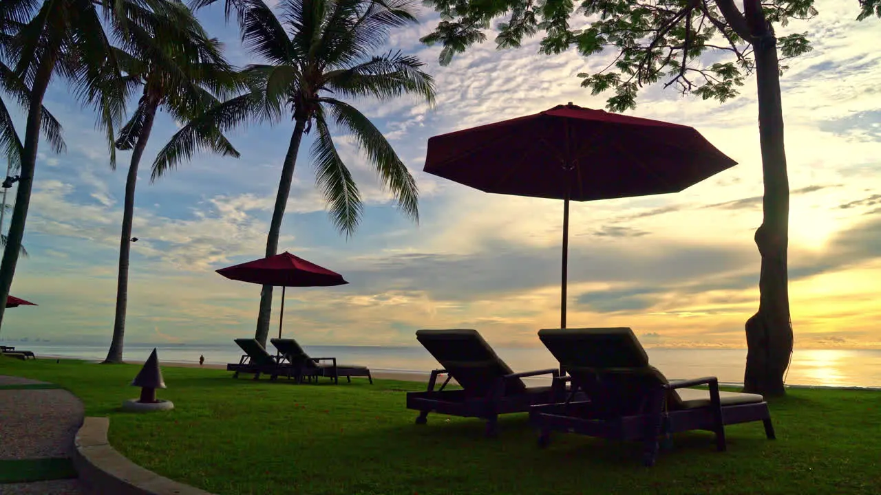 Umbrella with chair with sea beach background and sunrise in morning vacation and holiday concept