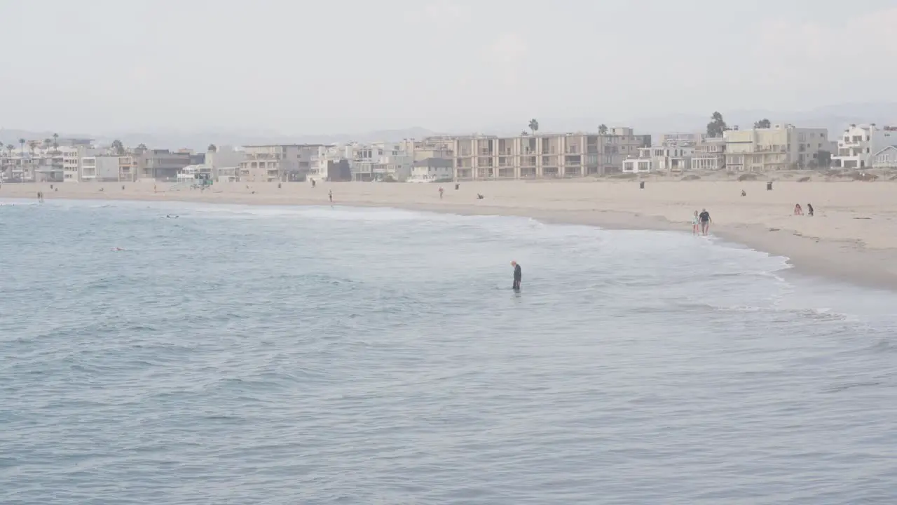 one man step to the water on Venice beach of Los Angeles USA