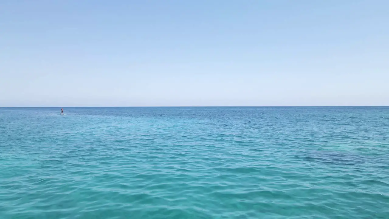 Drone skims across the surface of the turquoise sea in Zakynthos island Greece