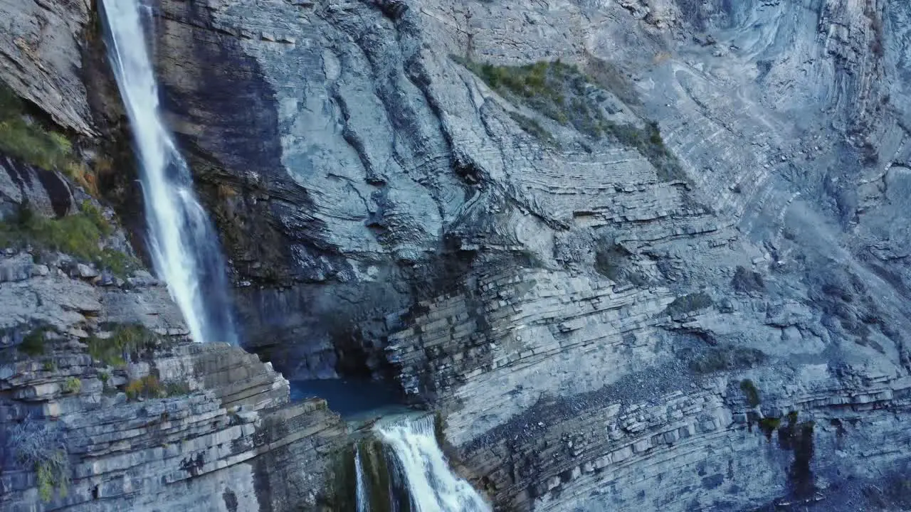 Rapid waterfall flowing through rocky cliff slope