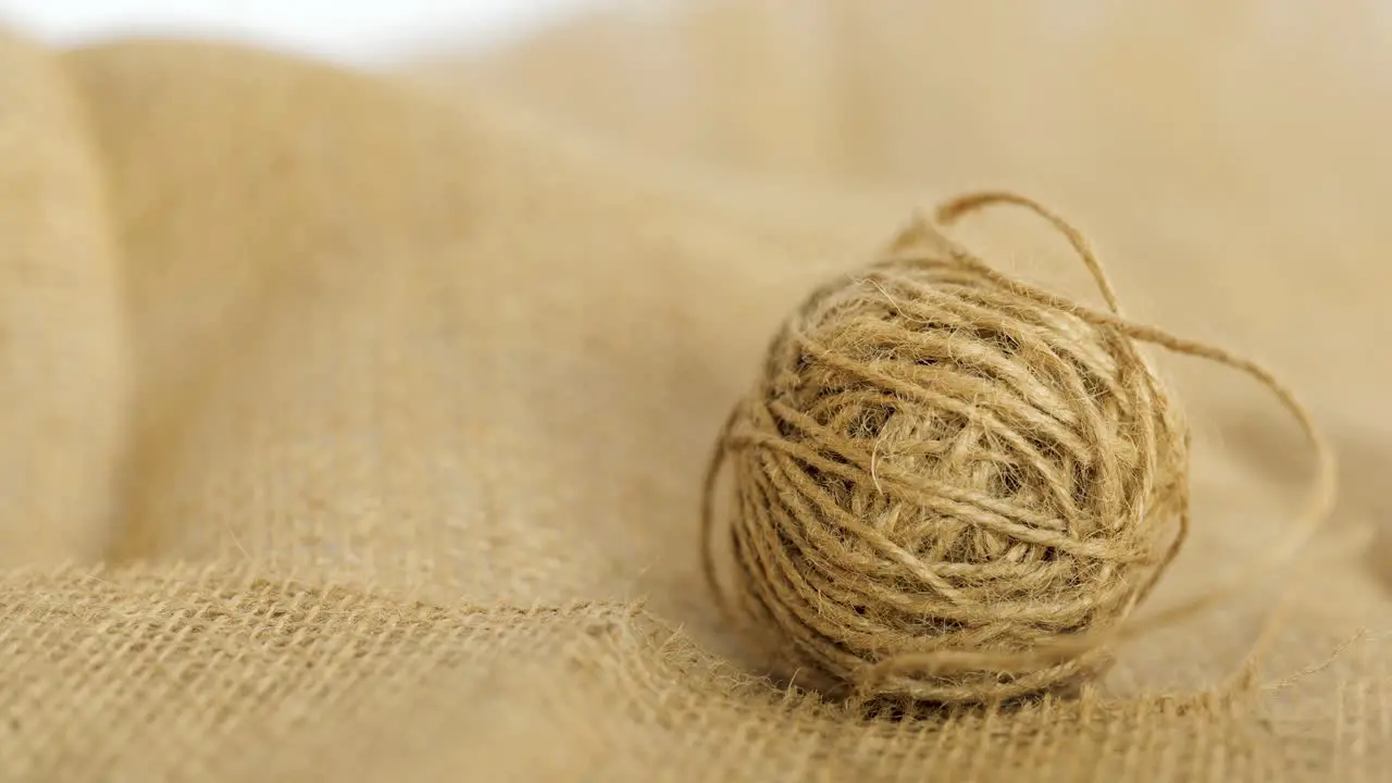 Closeup Of A Hand Grabbing A Ball Of Burlap Natural Jute Hessian Fibre Textile