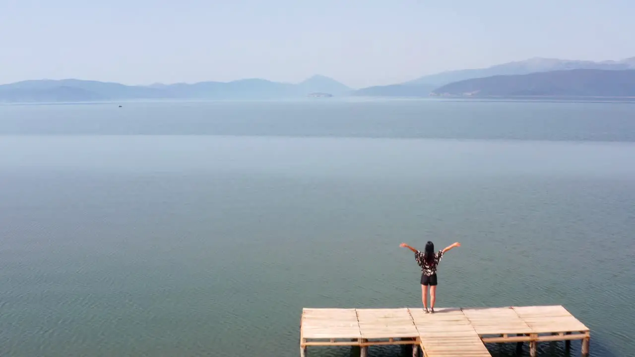 Woman raising her arms happily at the end