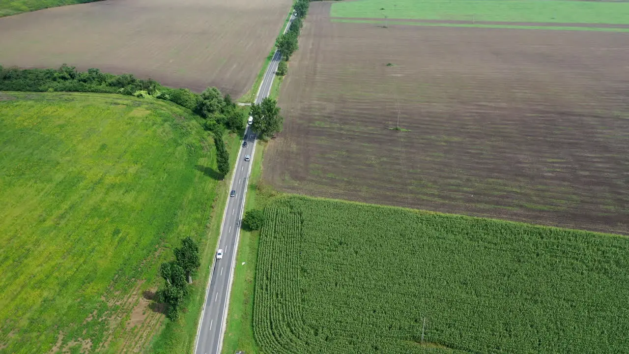 Straight 2 lane with cars and trucks driving back and forward