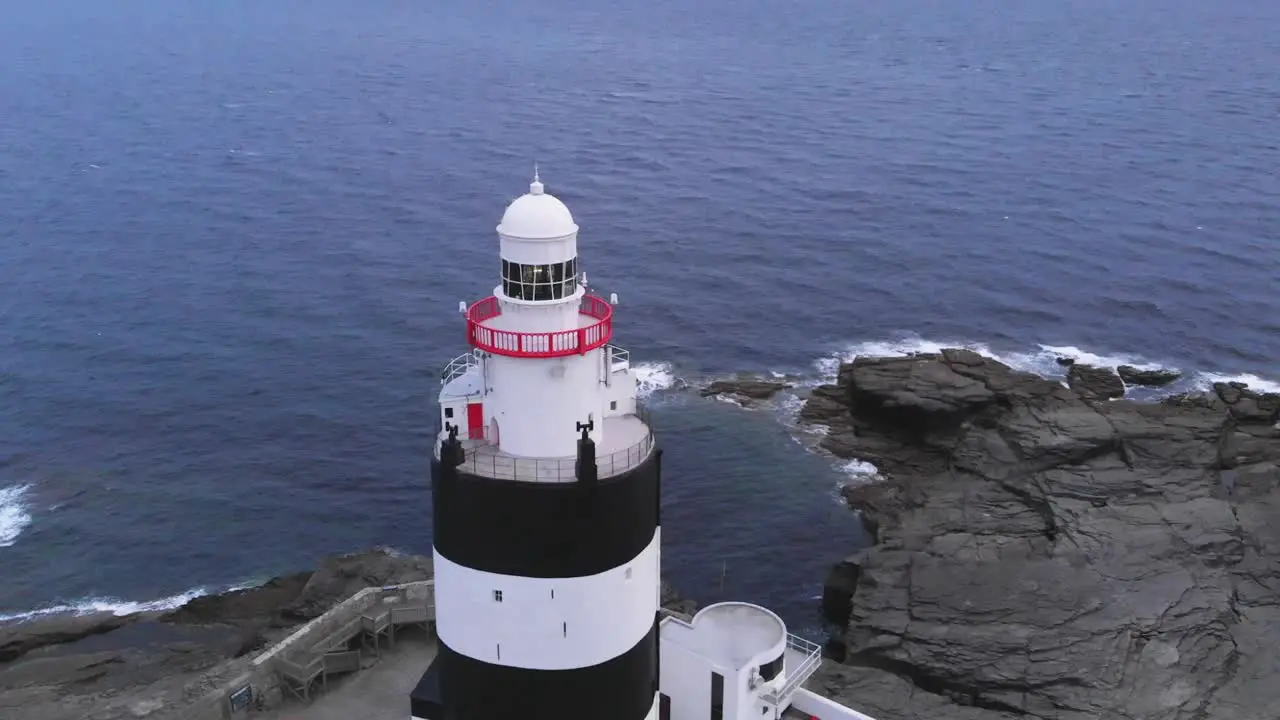 Aerial view of lighthouse over sea in daytime