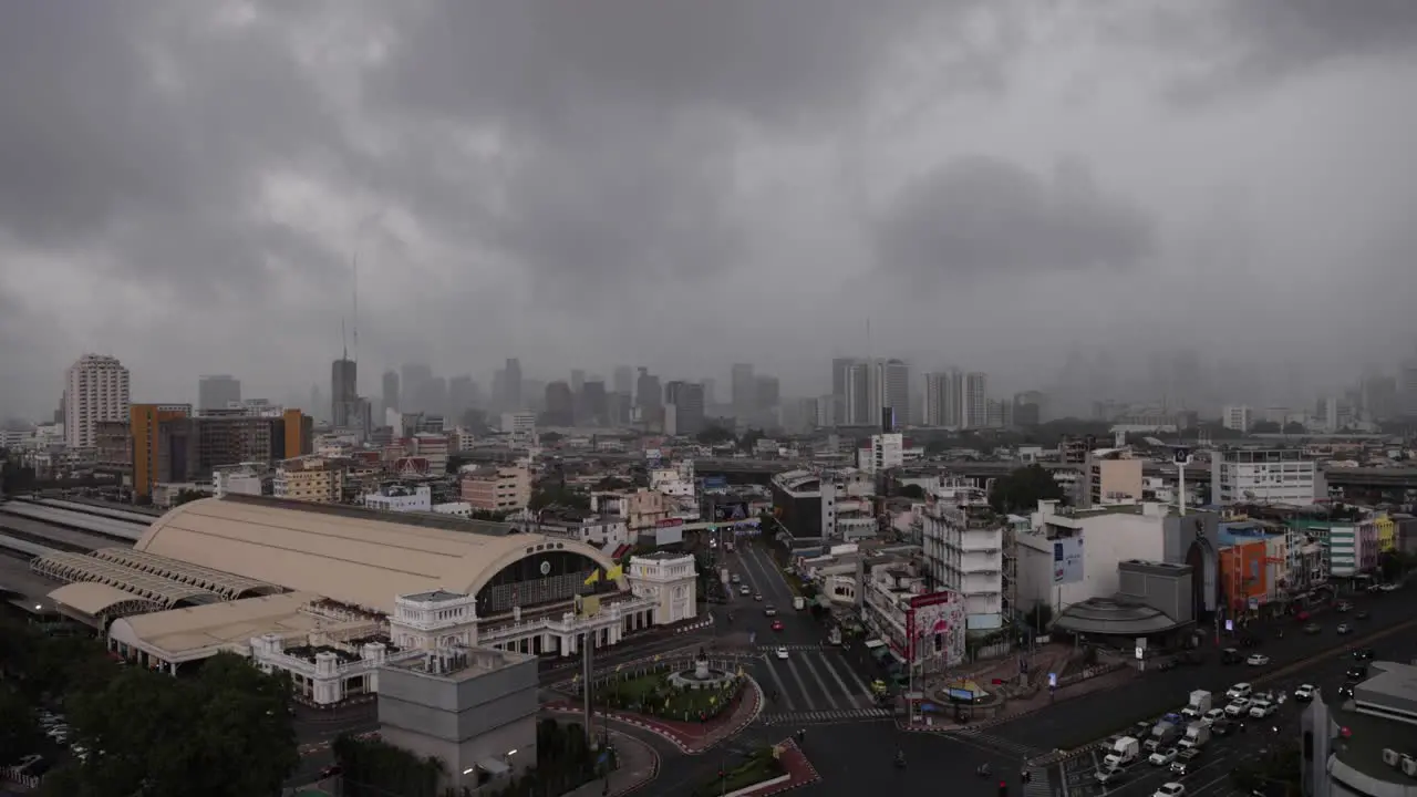 Dramatic stormy clouds with Lightning over the Bangkok skyscrapers and Hua Lamphong Railway Station