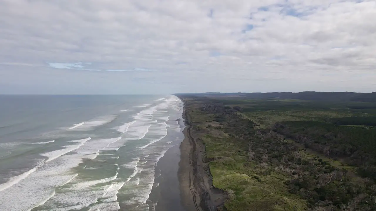 Push out showing the whole coastline at the black sand Muriwai Beach New Zealand