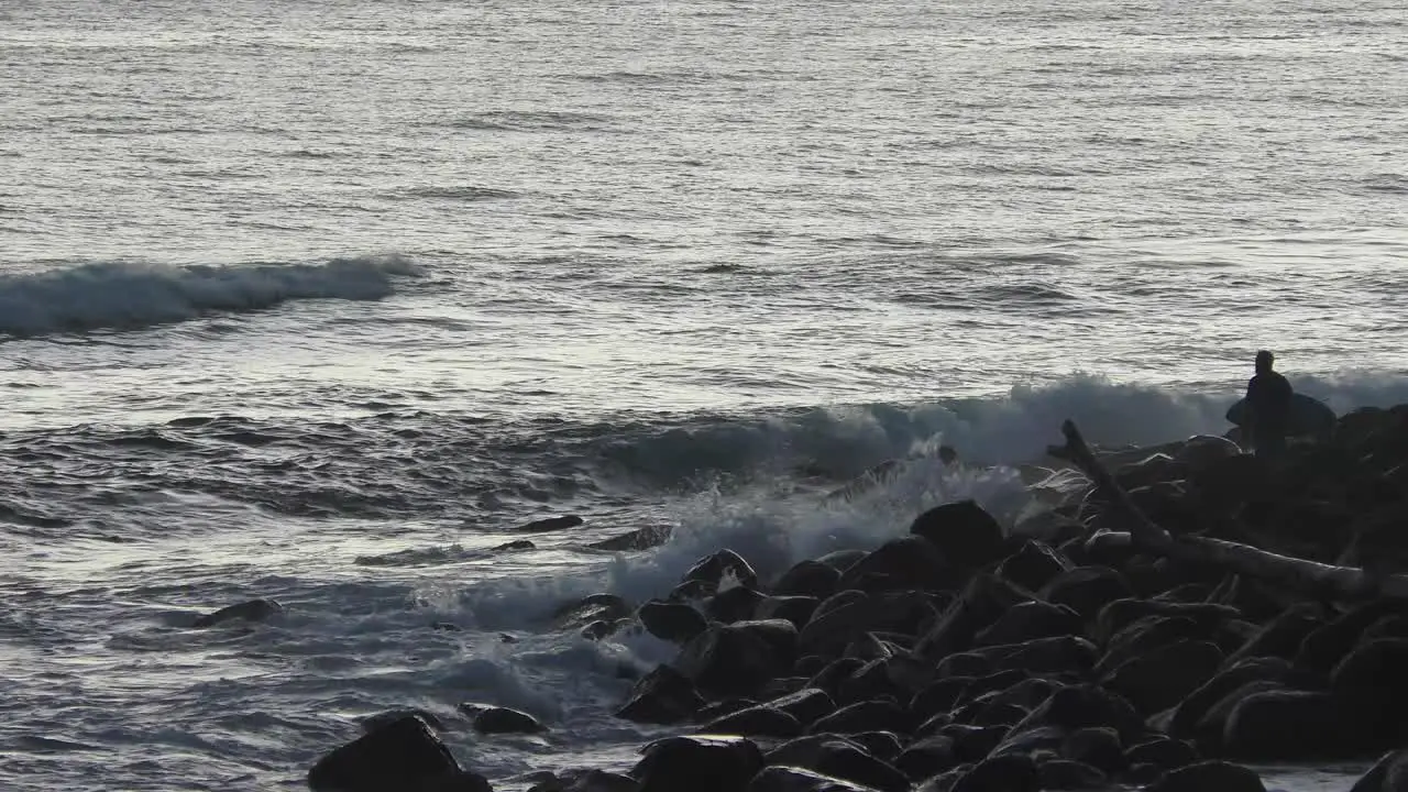 Man With Surfboard Waiting for Sunrise at Coastal Shore