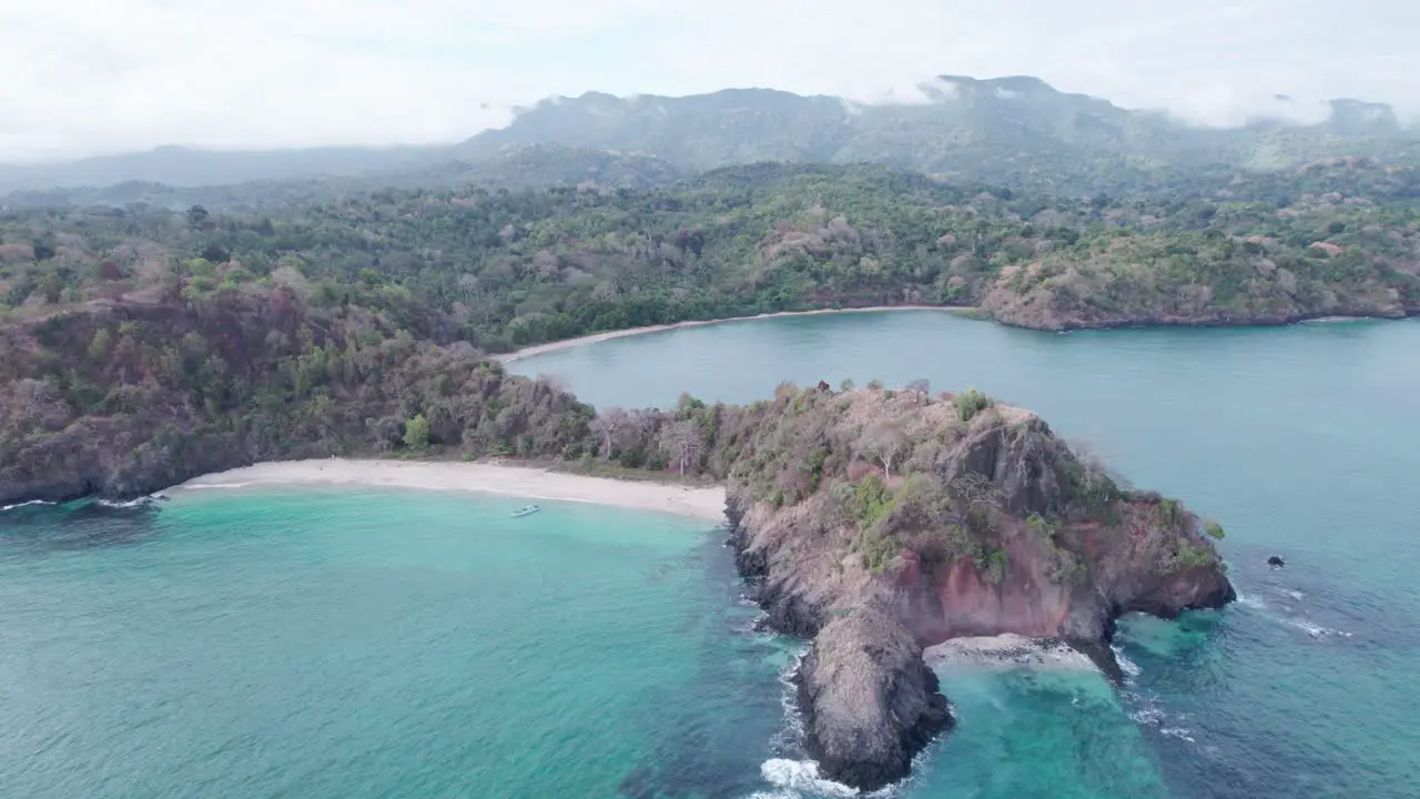 Small slice of island with beach and rocks crashing perfect destination