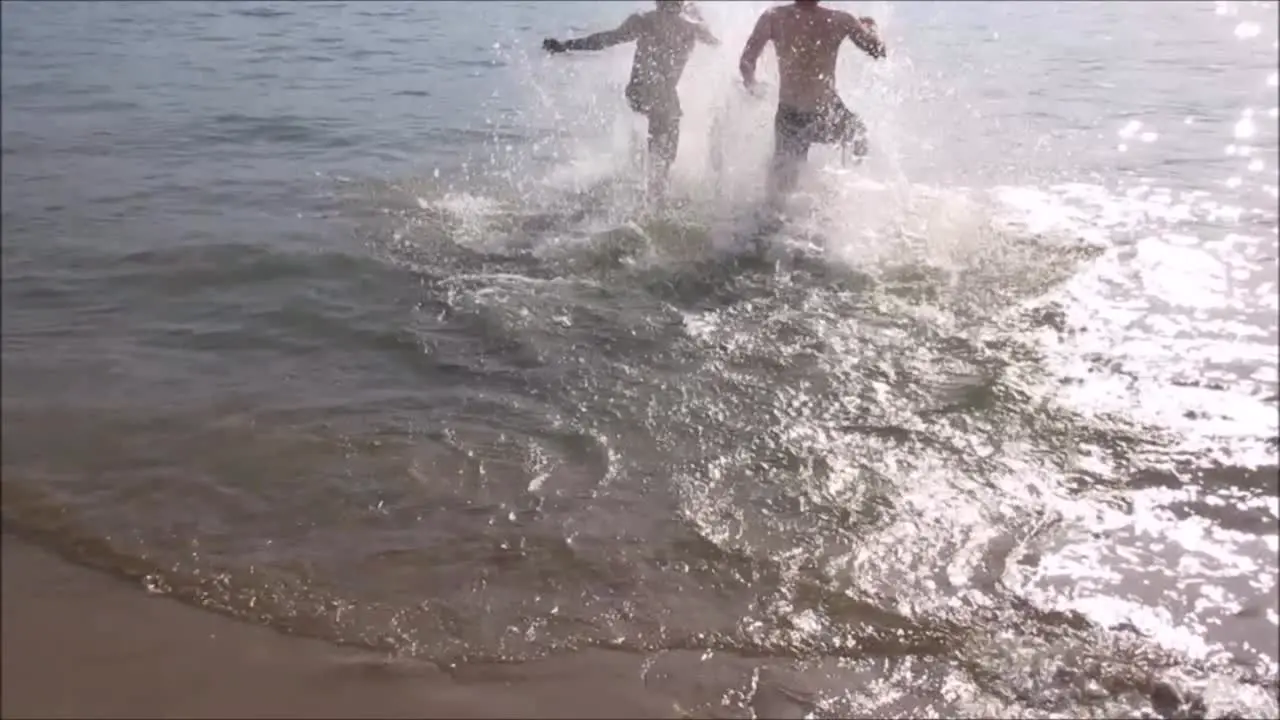 Two Men Running into Lake