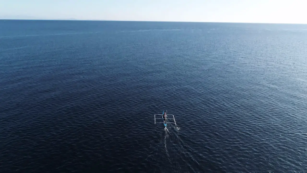 Above traditional Philippines outrigger boat going to fishing grounds off shore