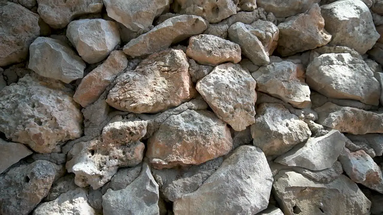 Down dolly slide Wall of large uncut stones with visible cement between the stones