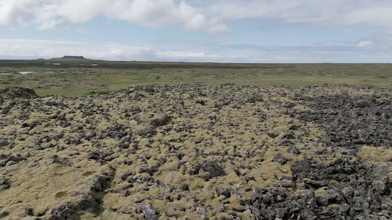 Flying Over Rocky Volcanic Terrain In Iceland On A Sunny Day