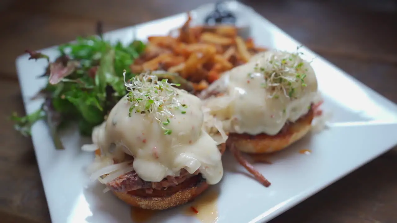 Eggs Benedict breakfast fries and salad